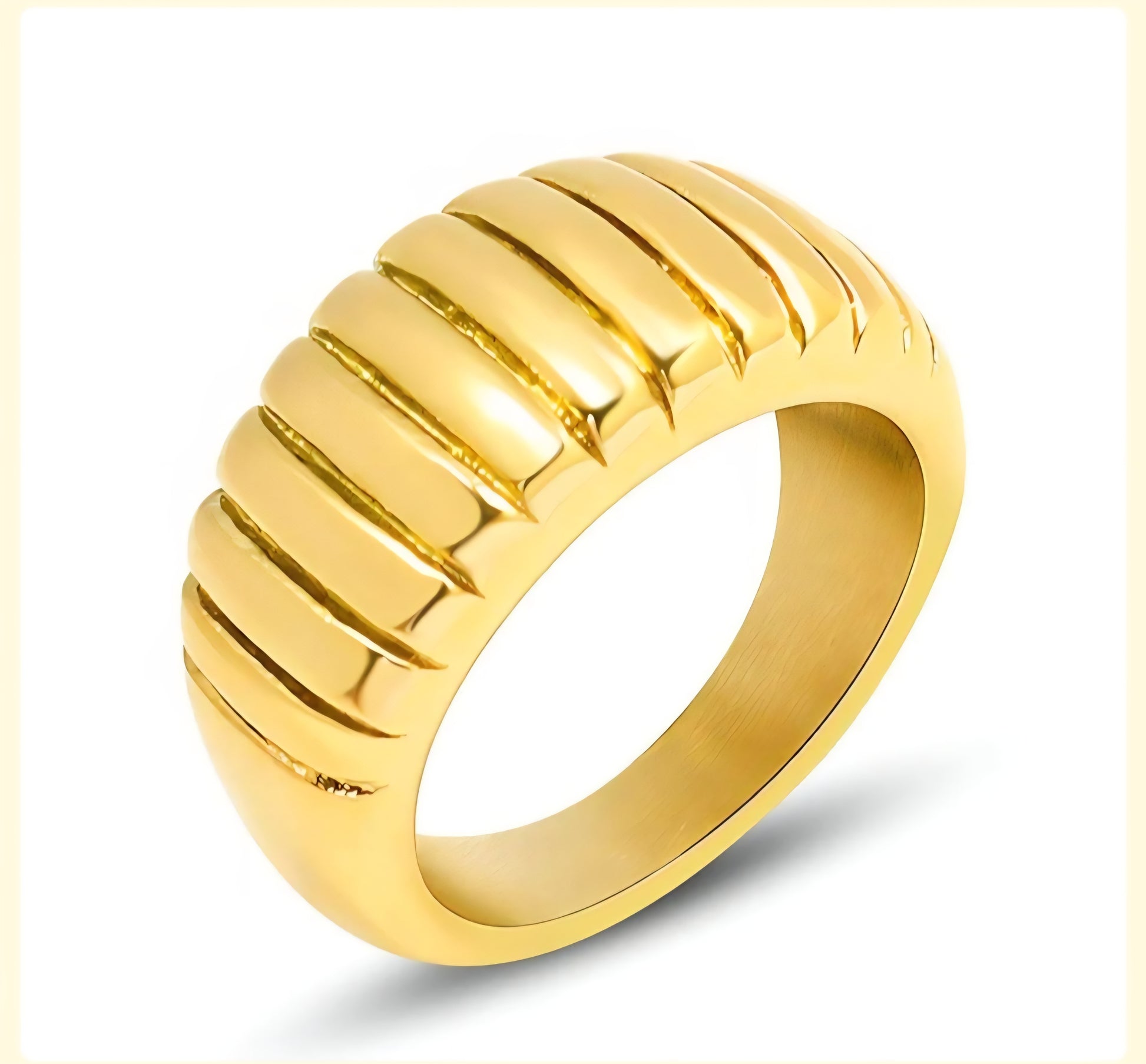 Gold ring with ribbed design on a white background