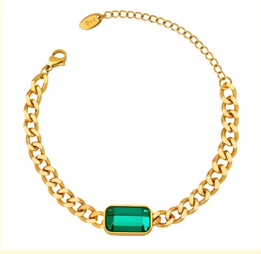 Gold chain bracelet with a green gemstone on a white background