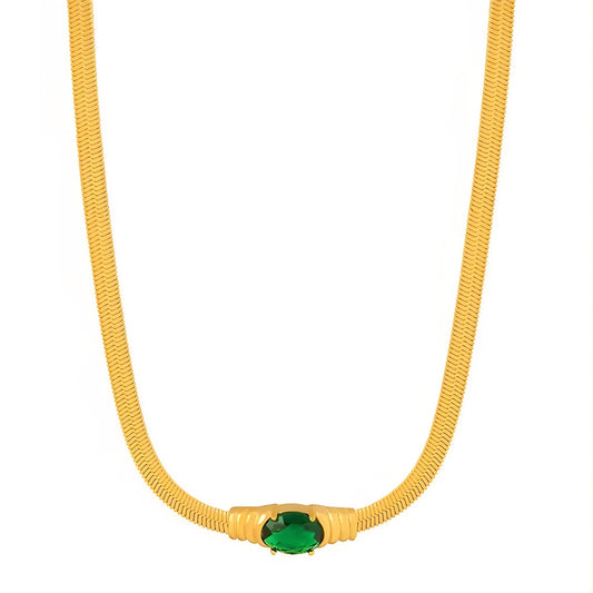 Gold necklace with a green gemstone on a white background