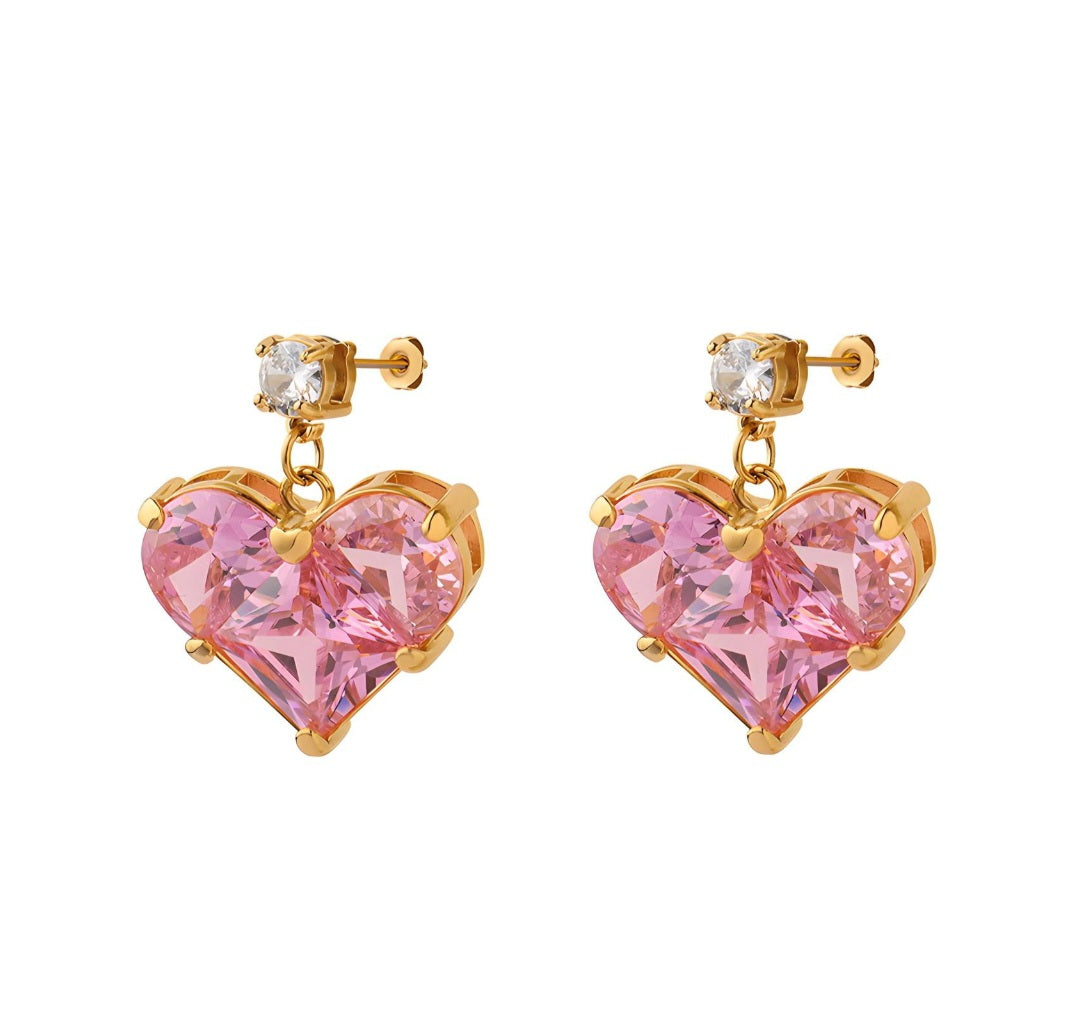 Heart-shaped earrings with pink cubic zirconia crystals and gold accents on a white background Zirconia 