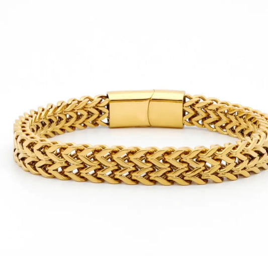 Gold braided bracelet with a magnetic clasp on a white background