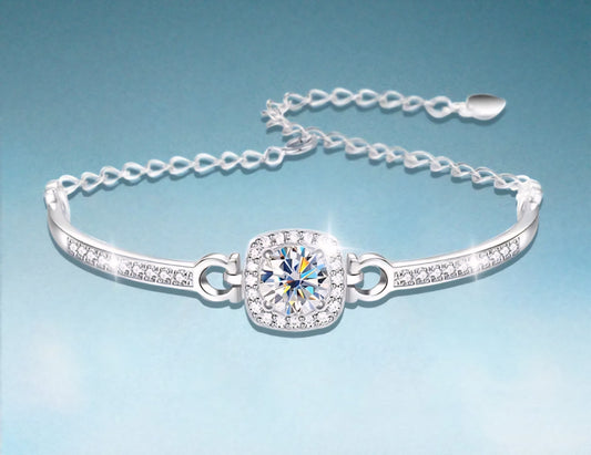 Silver bracelet with a central Moissanite crystal on a light blue background