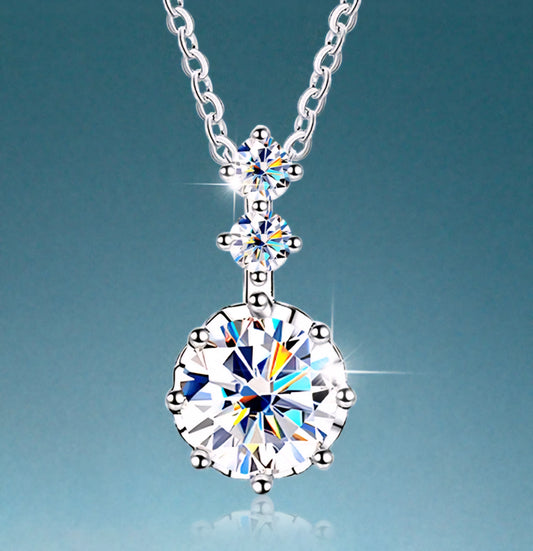 Silver necklace with a large diamond pendant on a light blue background