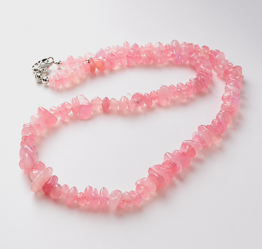 Pink beaded necklace on a white background