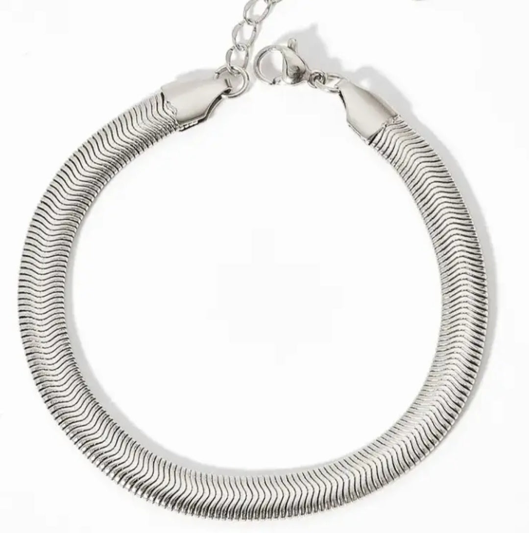 Silver herringbone bracelet on a white background