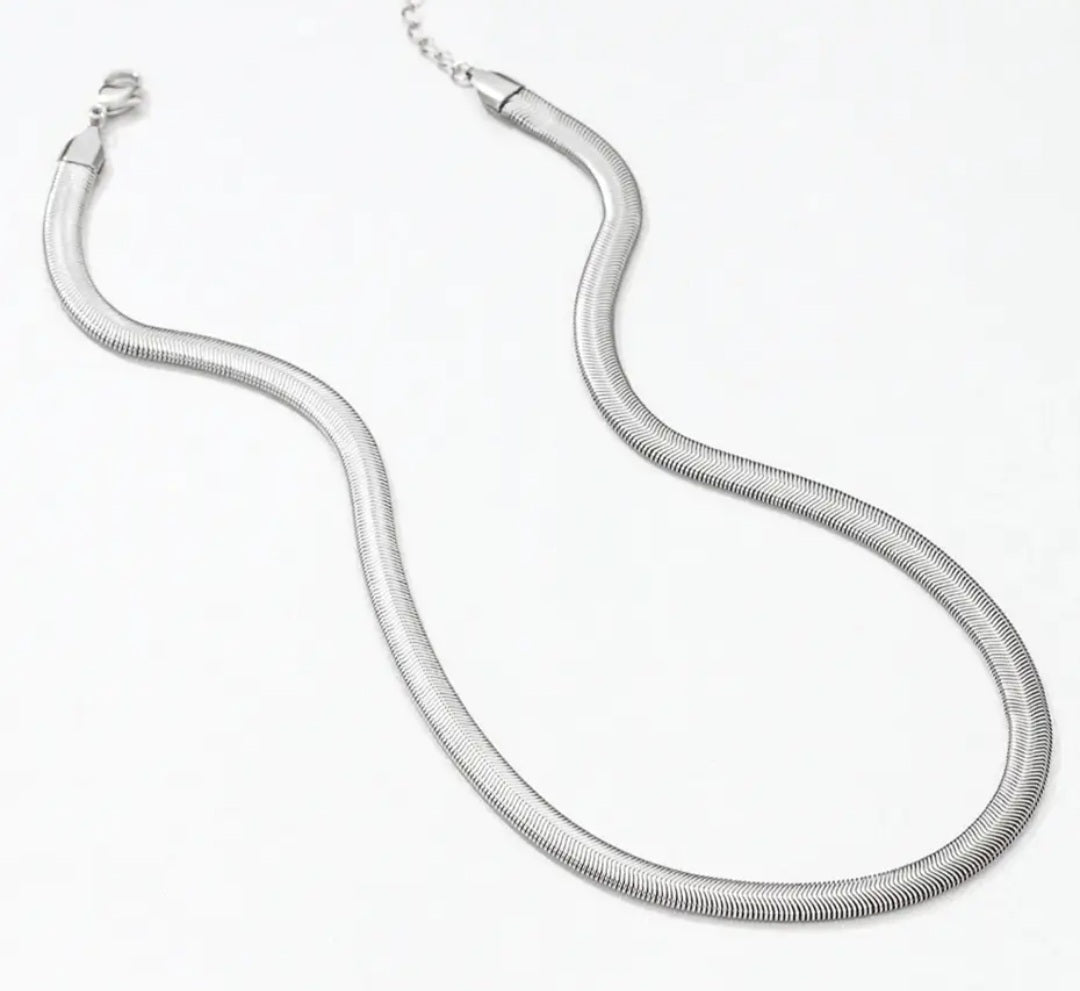 Silver herringbone necklaces on a white background