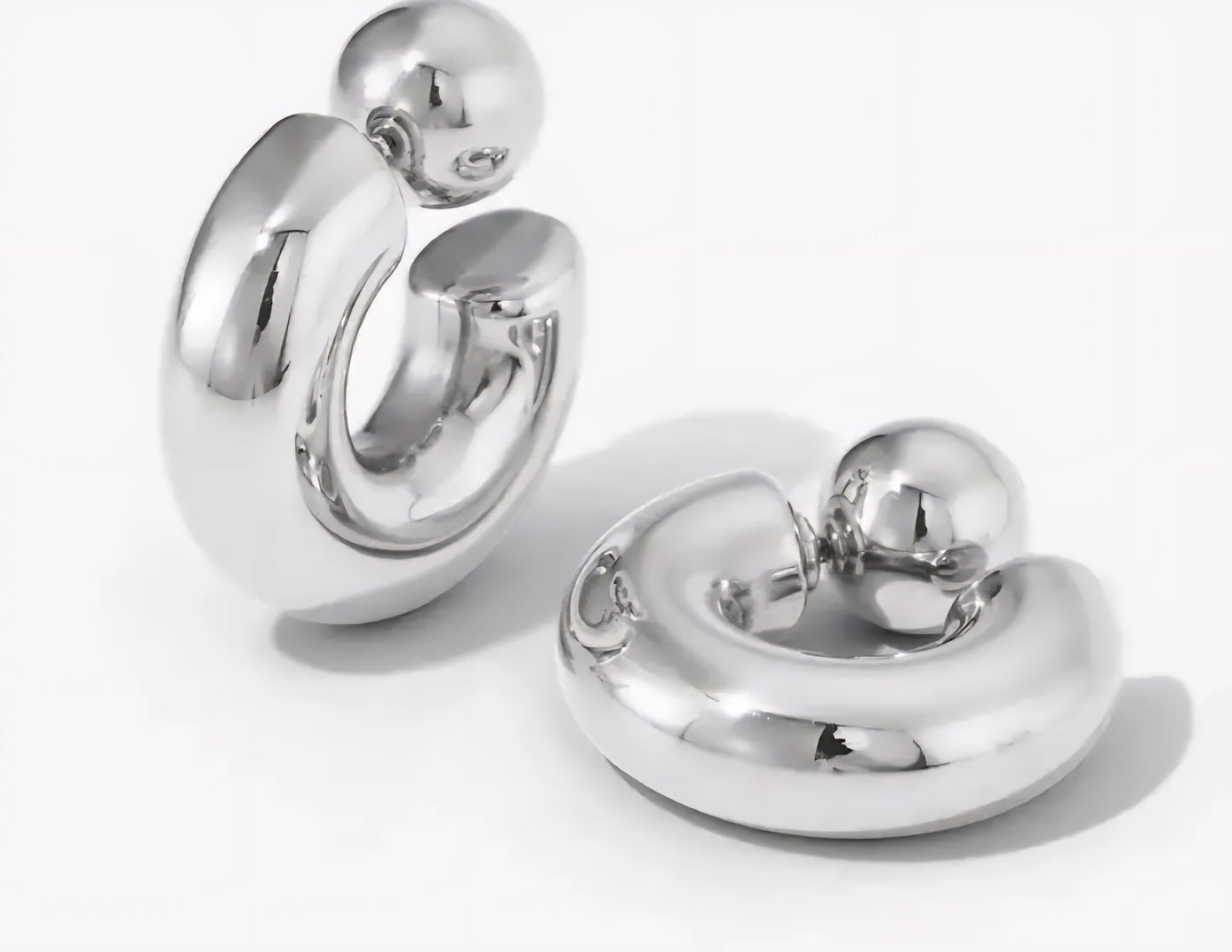 Pair of silver hoop earrings on a white background