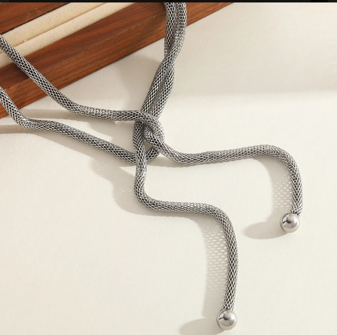 Silver necklace on a light background