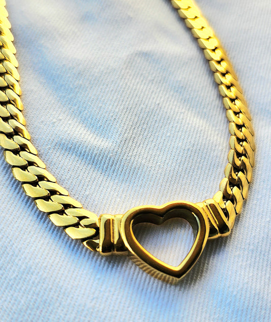 Gold necklace on a plain background