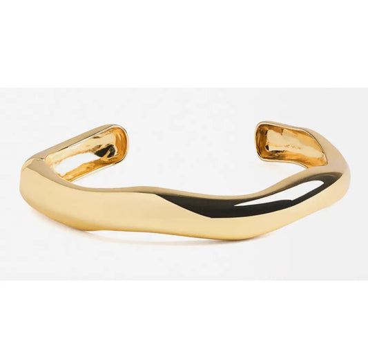 Gold open cuff bracelet on a white background