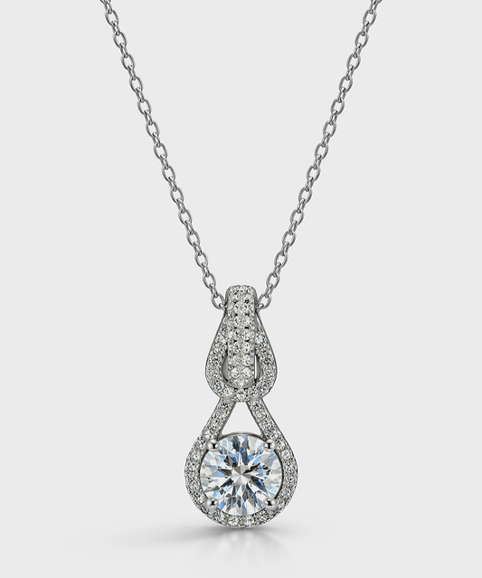 Necklace with Moissanite gemstone on a light gray background